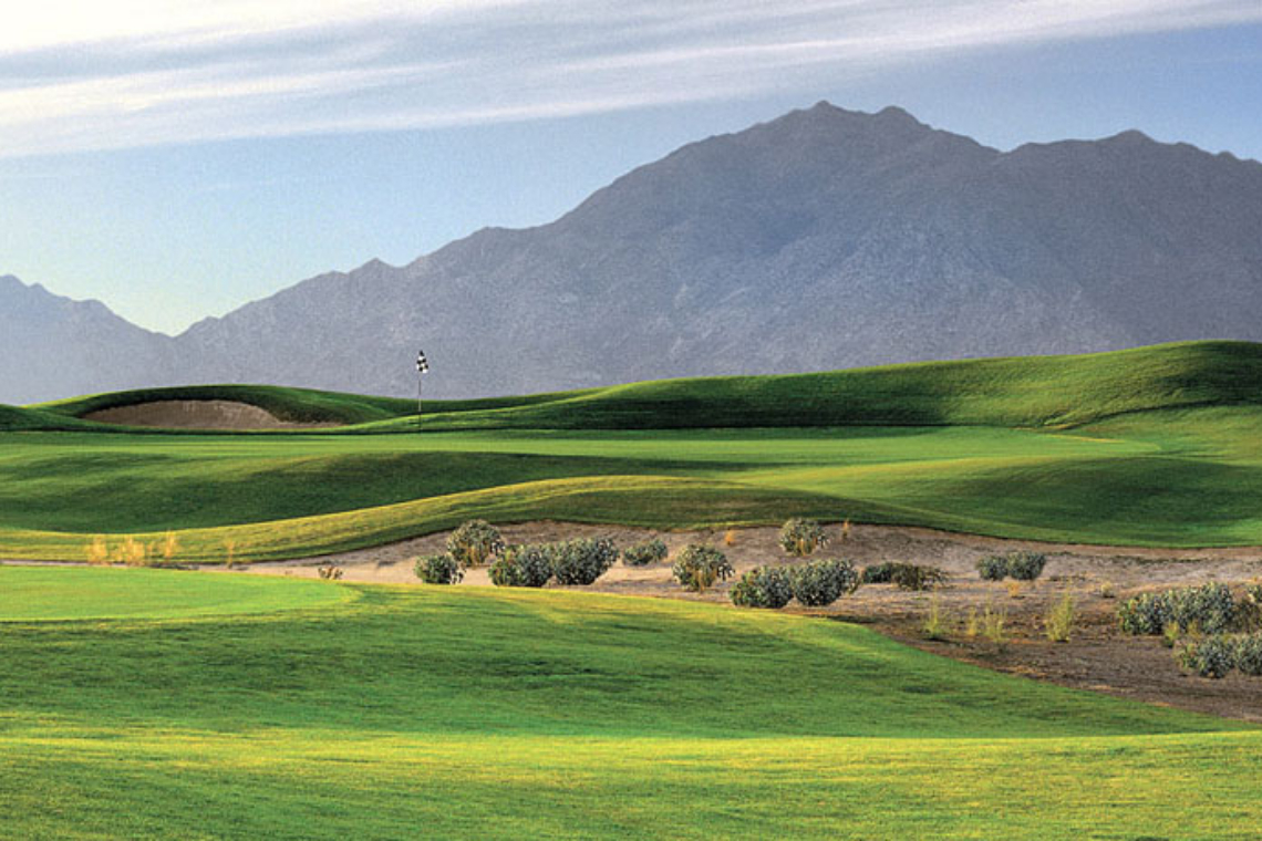 golf course green with mountains
